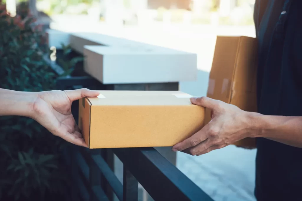 person-receiving-box-delivery-at-urban-home-2026-03-13-04-11-28-utc